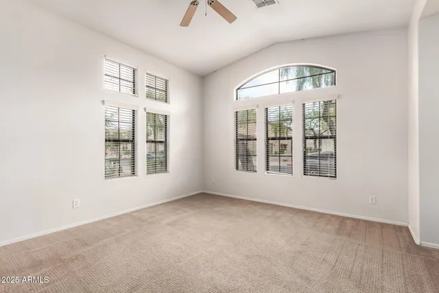 an empty room with a empty space and windows