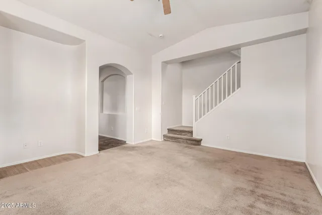 a view of an empty room with stairs