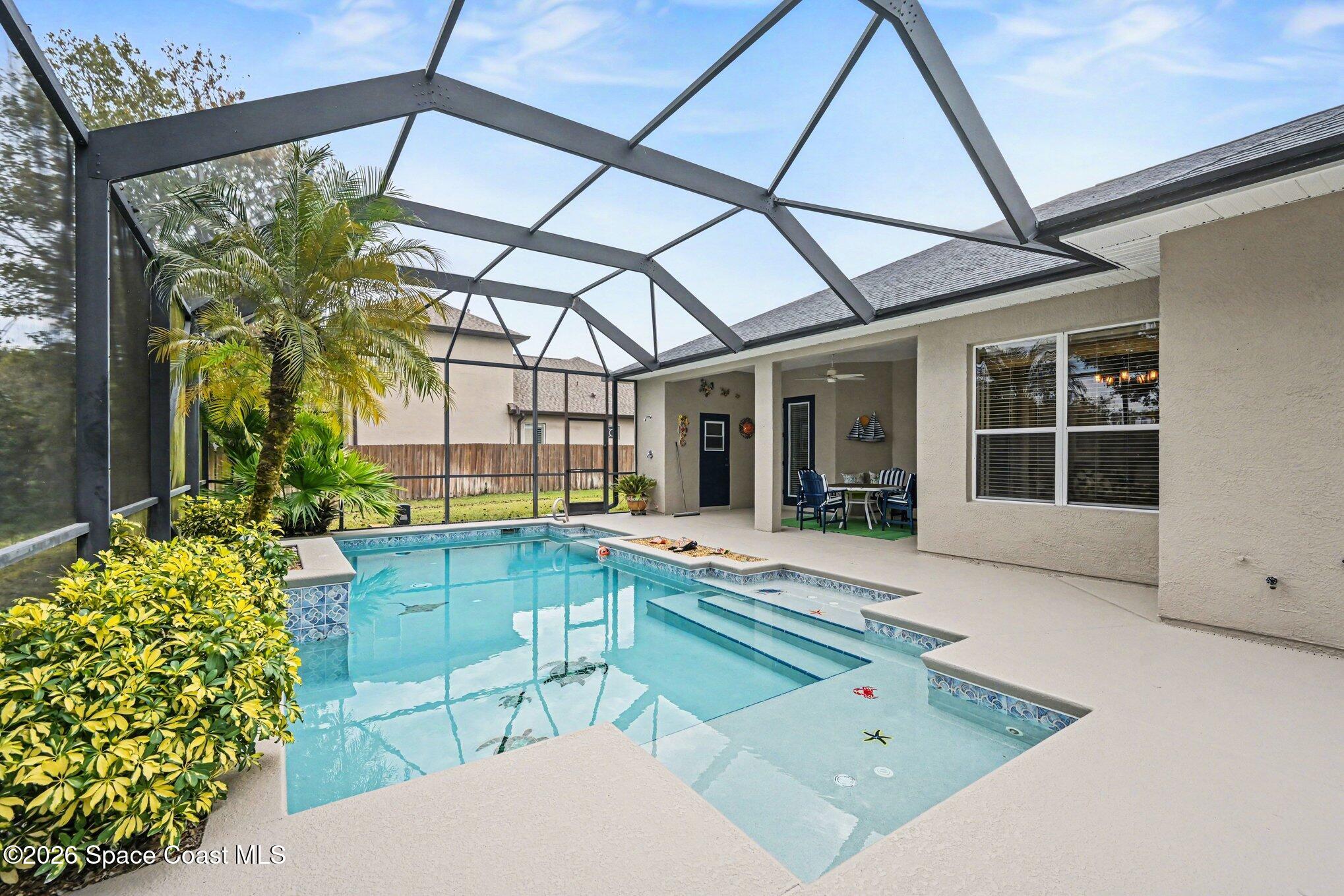 3760 Fringetree Lane Melbourne, FL 32940 - Photo 11 of 36 a swimming pool with outdoor seating and yard