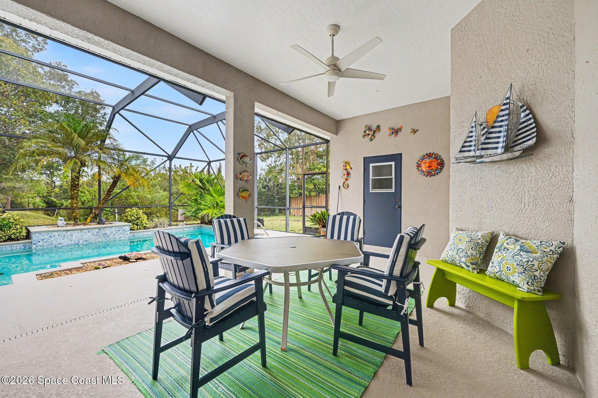 3760 Fringetree Lane Melbourne, FL 32940 - Photo 12 of 36 a dining room with furniture and a floor to ceiling window