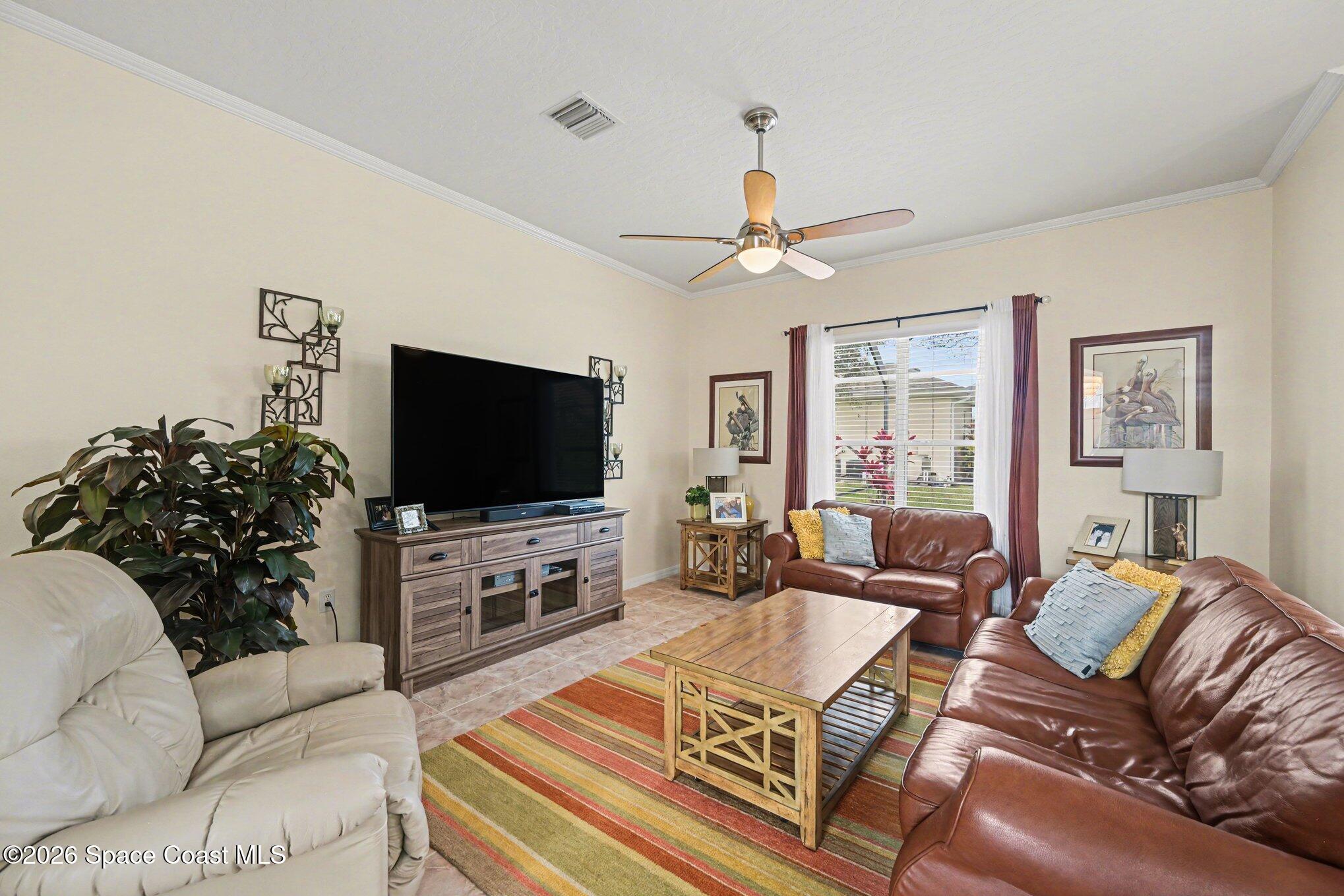 3760 Fringetree Lane Melbourne, FL 32940 - Photo 19 of 36 a living room with furniture and a flat screen tv