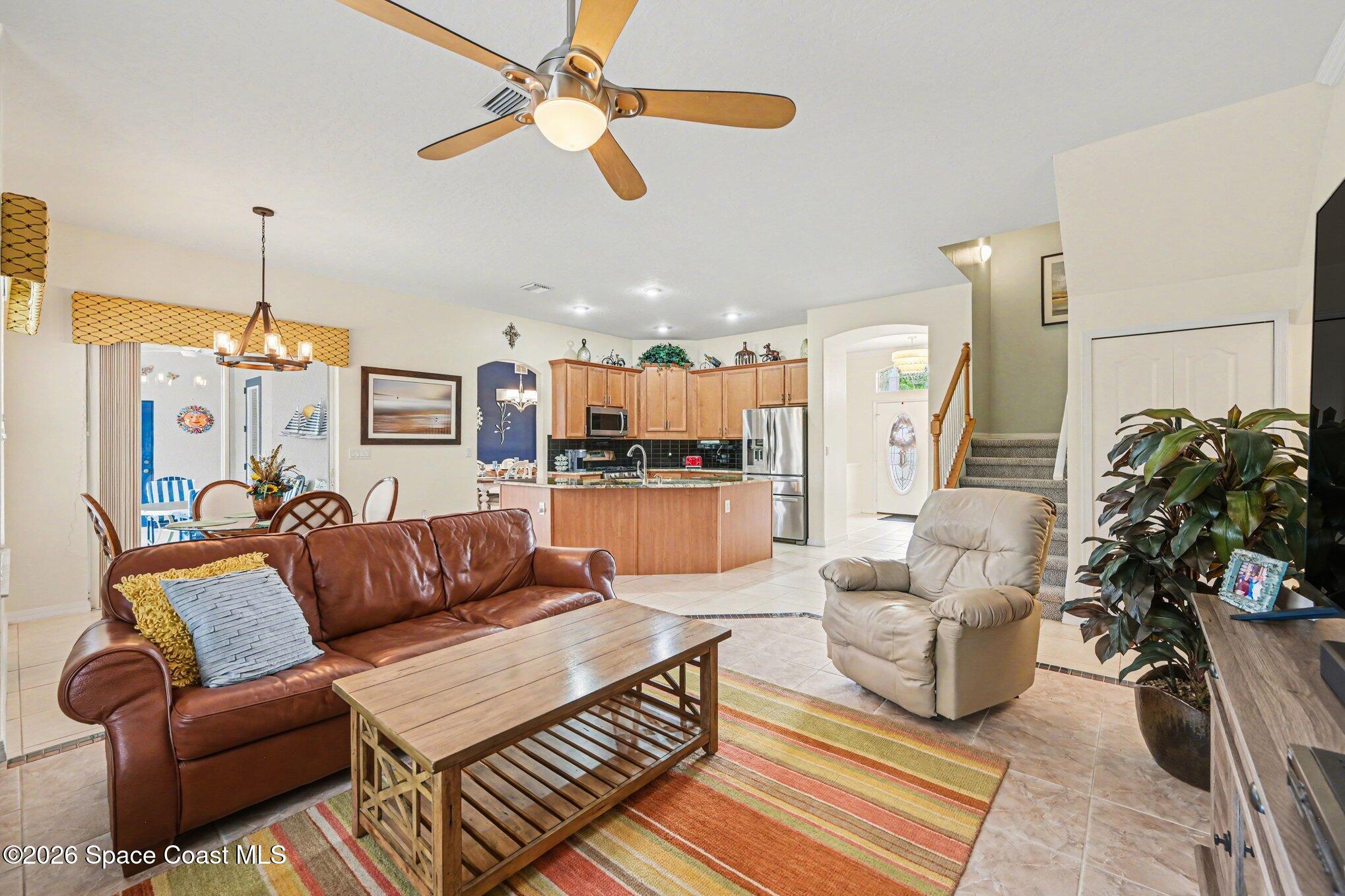 3760 Fringetree Lane Melbourne, FL 32940 - Photo 21 of 36 a living room with furniture kitchen view and a chandelier
