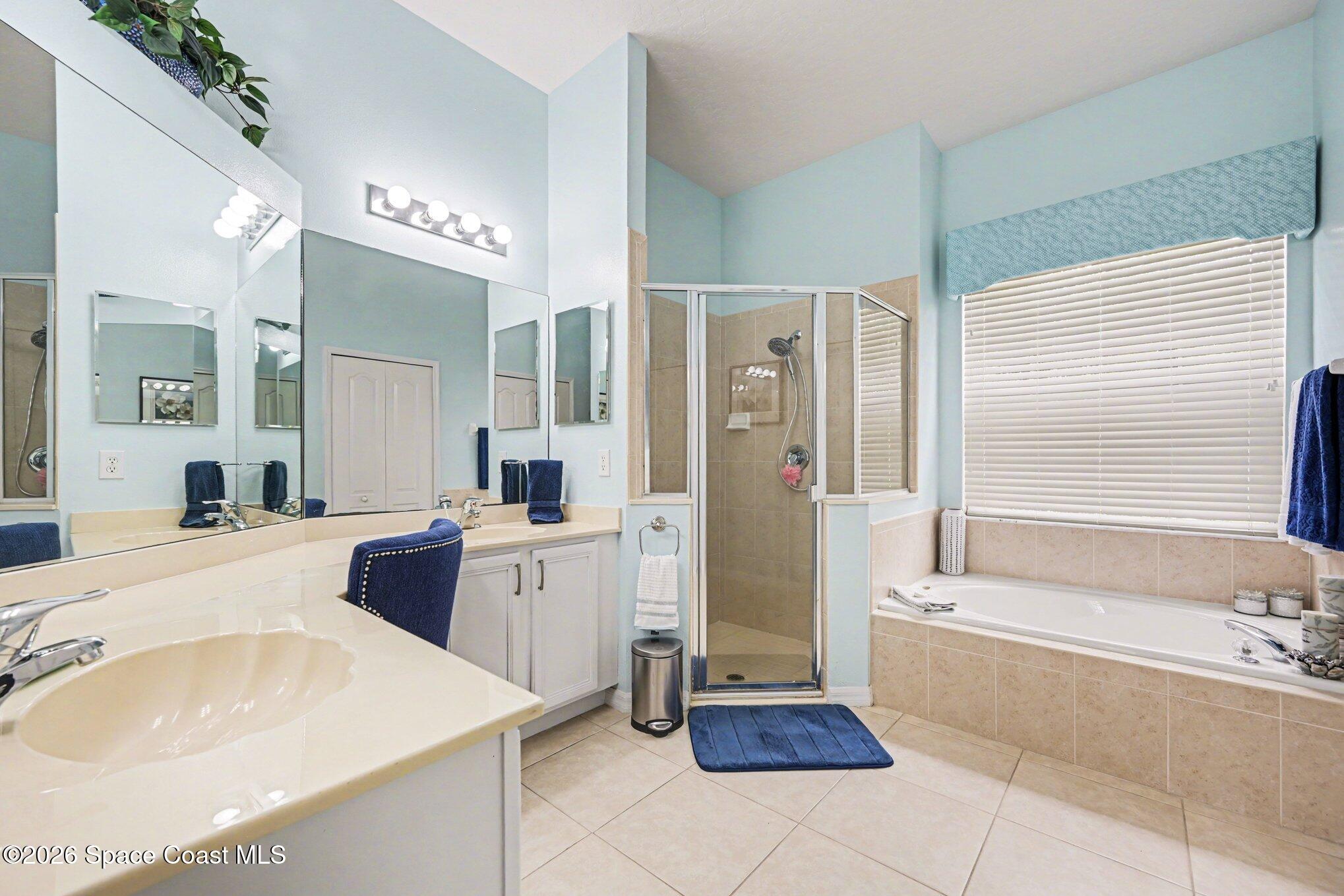 3760 Fringetree Lane Melbourne, FL 32940 - Photo 24 of 36 a large spacious bathroom with a tub sink and mirror