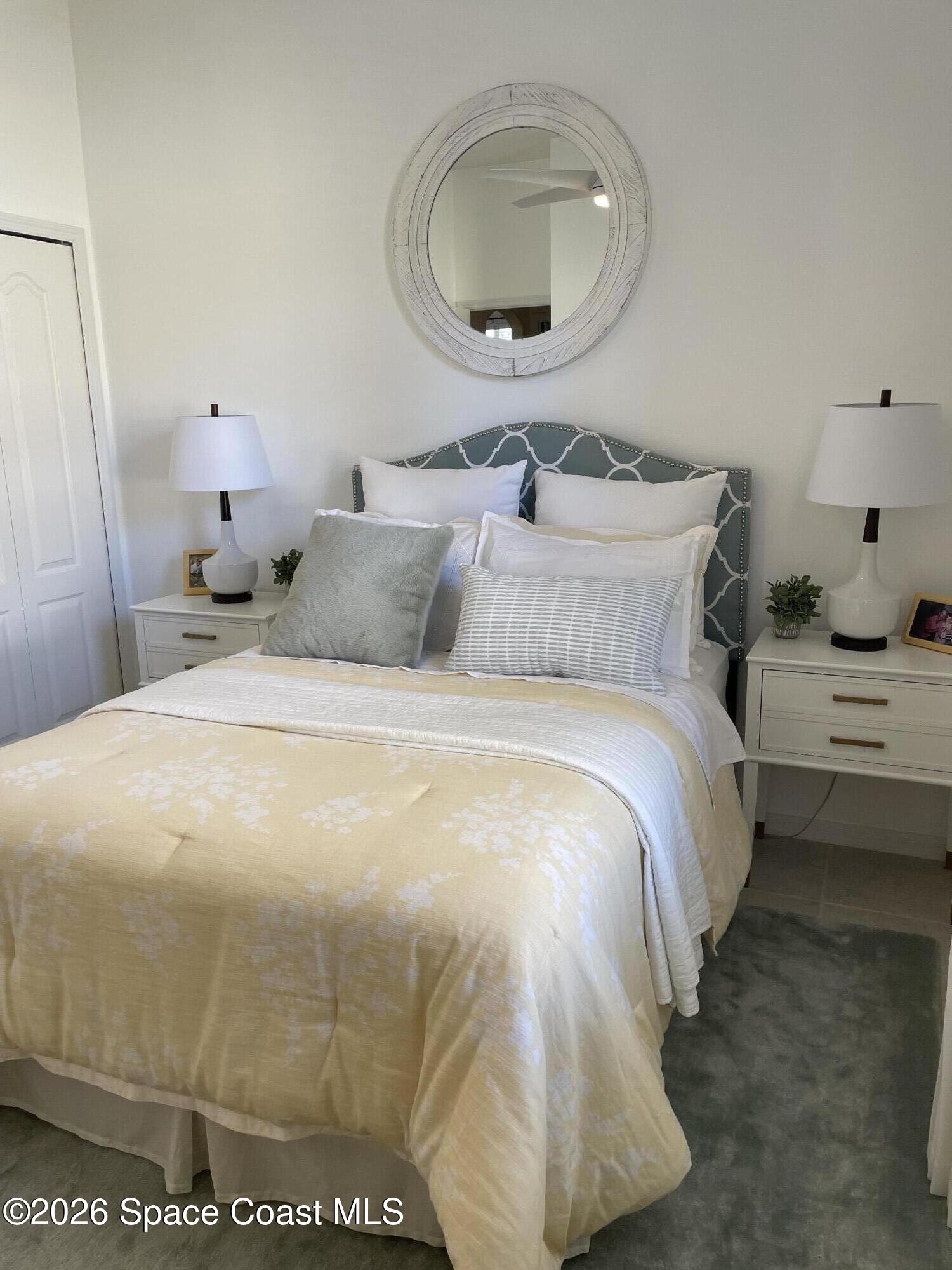 3760 Fringetree Lane Melbourne, FL 32940 - Photo 26 of 36 a bedroom with bed and a mirror