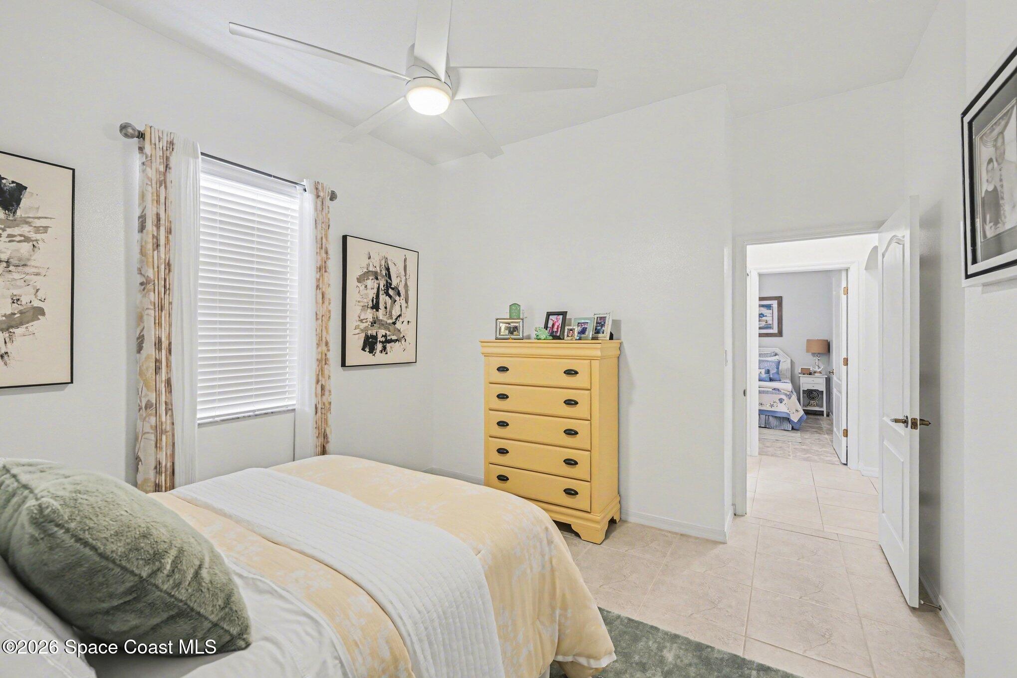 3760 Fringetree Lane Melbourne, FL 32940 - Photo 27 of 36 a bedroom with a bed and a cabinets