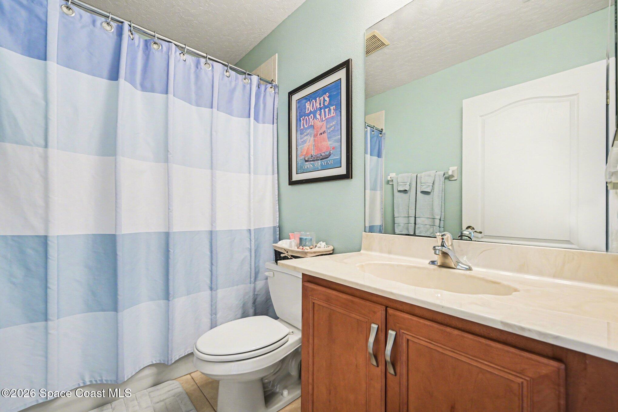 3760 Fringetree Lane Melbourne, FL 32940 - Photo 28 of 36 a bathroom with a sink a toilet and a mirror