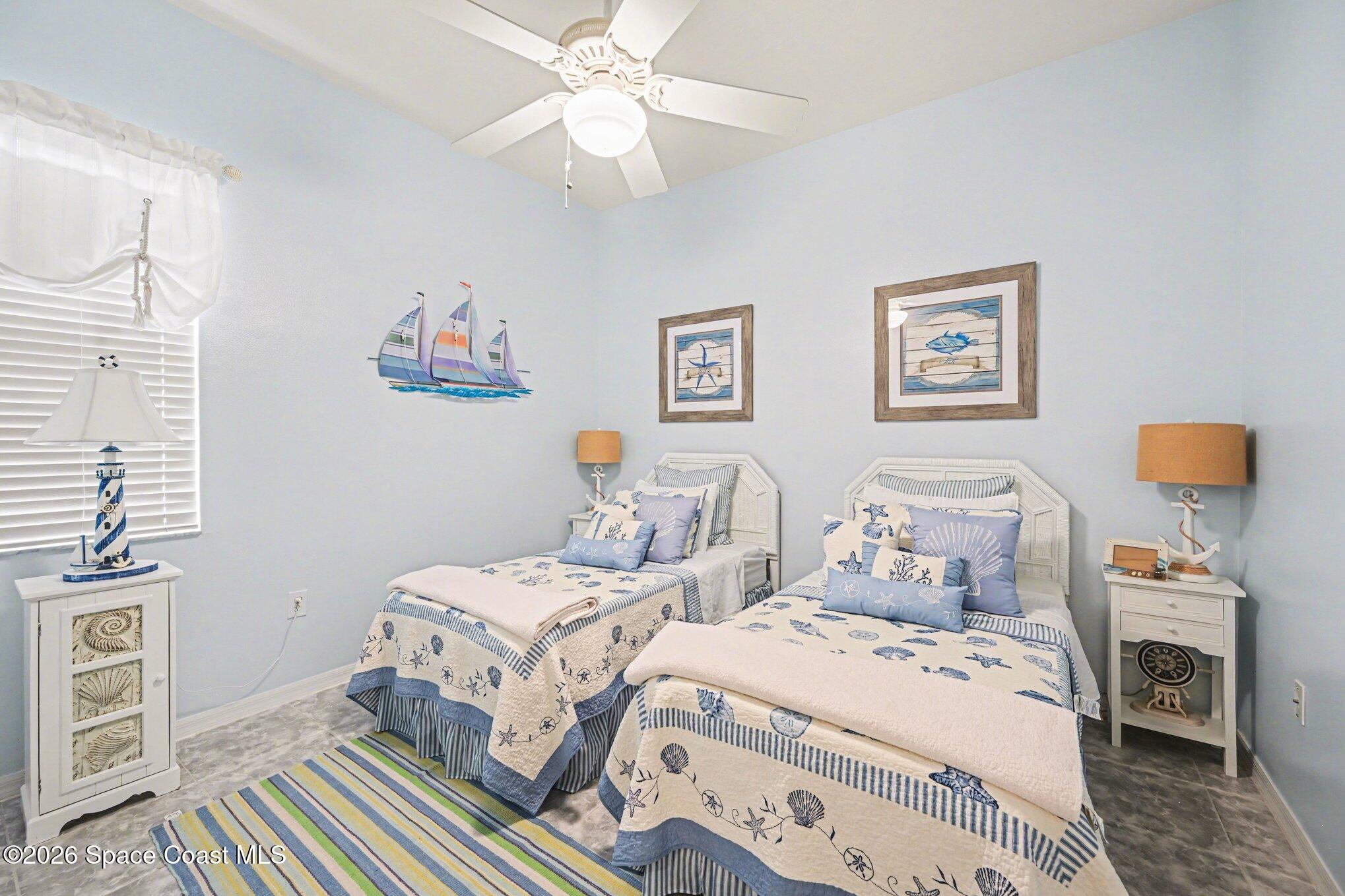 3760 Fringetree Lane Melbourne, FL 32940 - Photo 29 of 36 a bedroom with two beds and a window