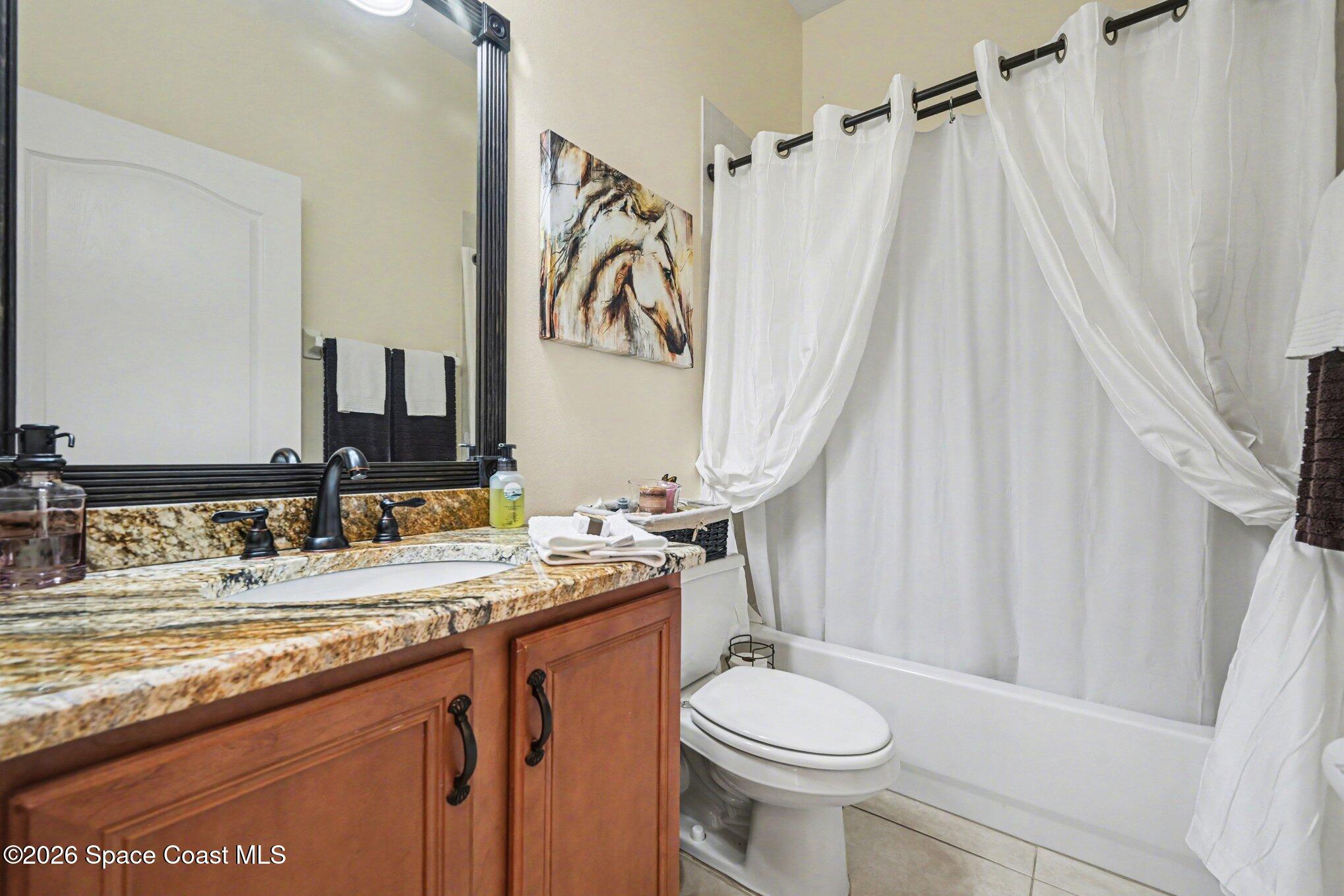 3760 Fringetree Lane Melbourne, FL 32940 - Photo 31 of 36 a bathroom with a granite countertop sink toilet and shower