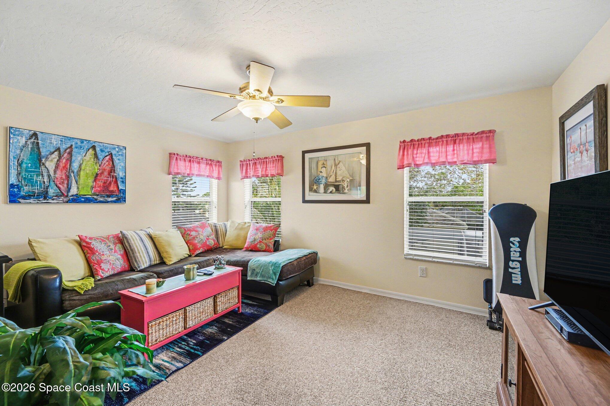 3760 Fringetree Lane Melbourne, FL 32940 - Photo 32 of 36 a living room with furniture and a flat screen tv
