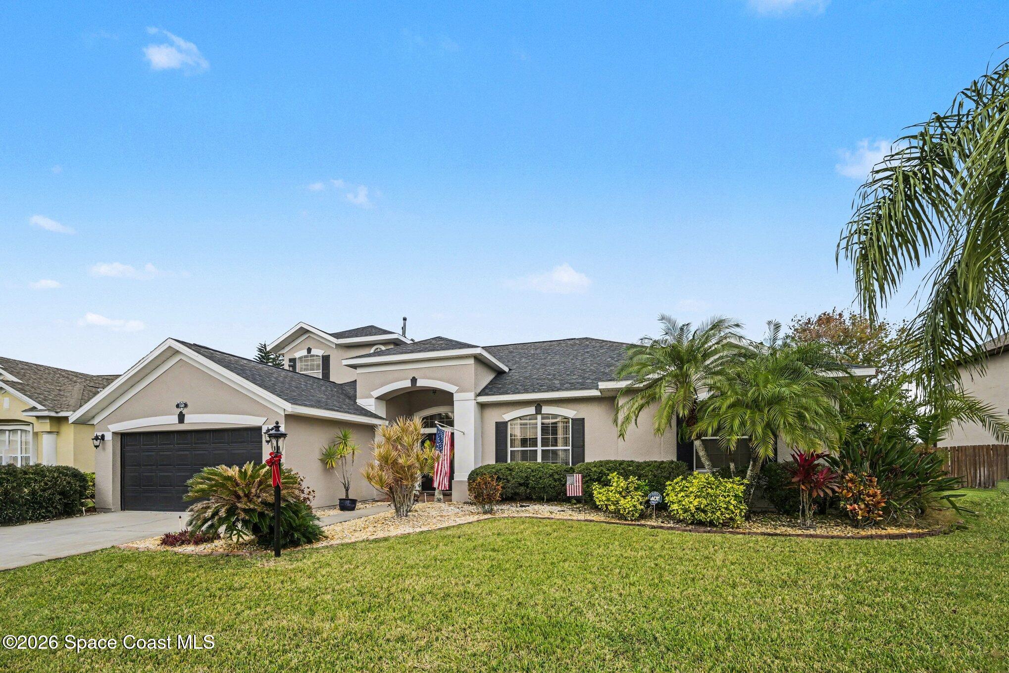 3760 Fringetree Lane Melbourne, FL 32940 - Photo 35 of 36 a front view of a house with a garden