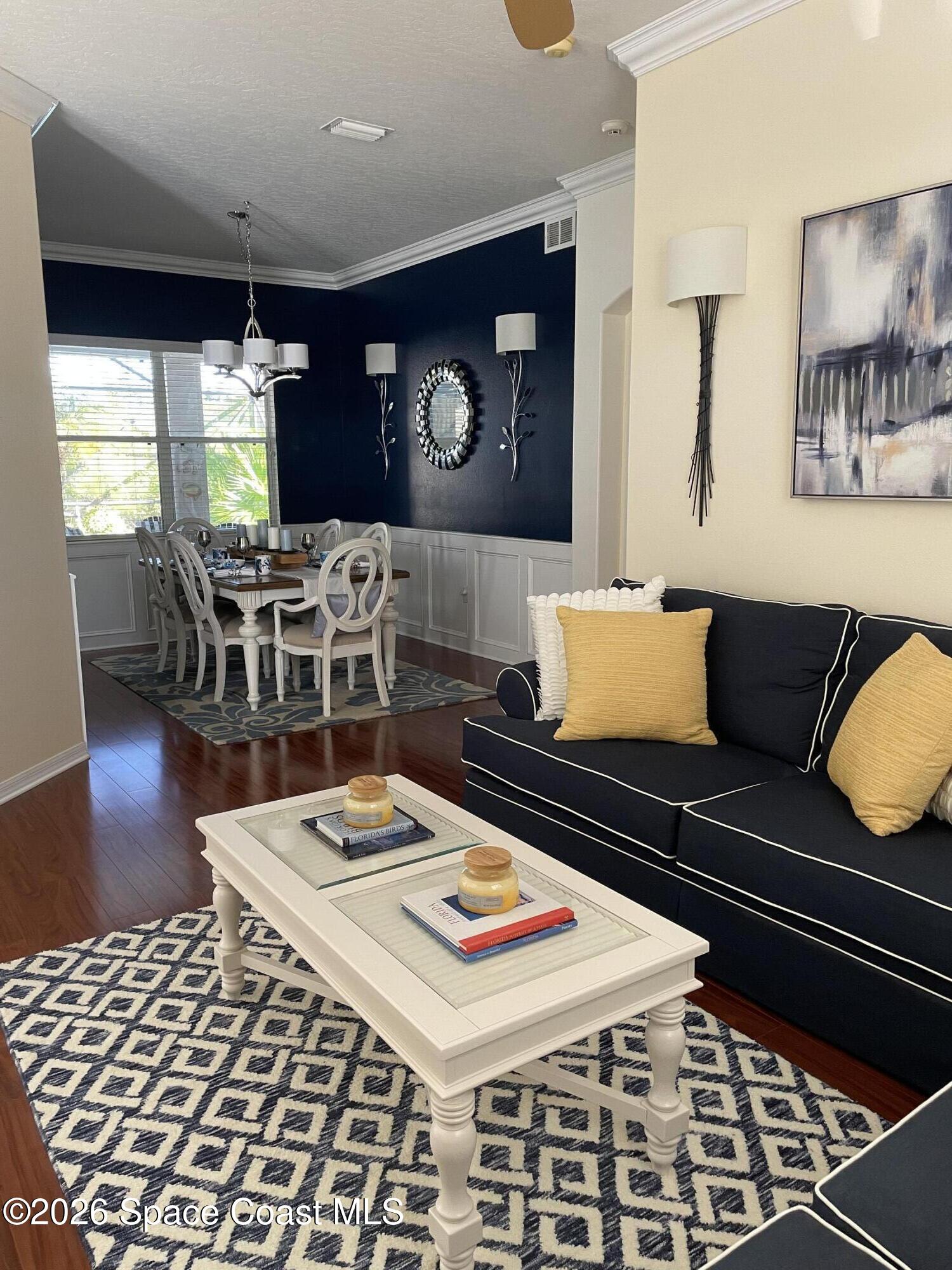 3760 Fringetree Lane Melbourne, FL 32940 - Photo 5 of 36 a living room with furniture a rug and a fireplace