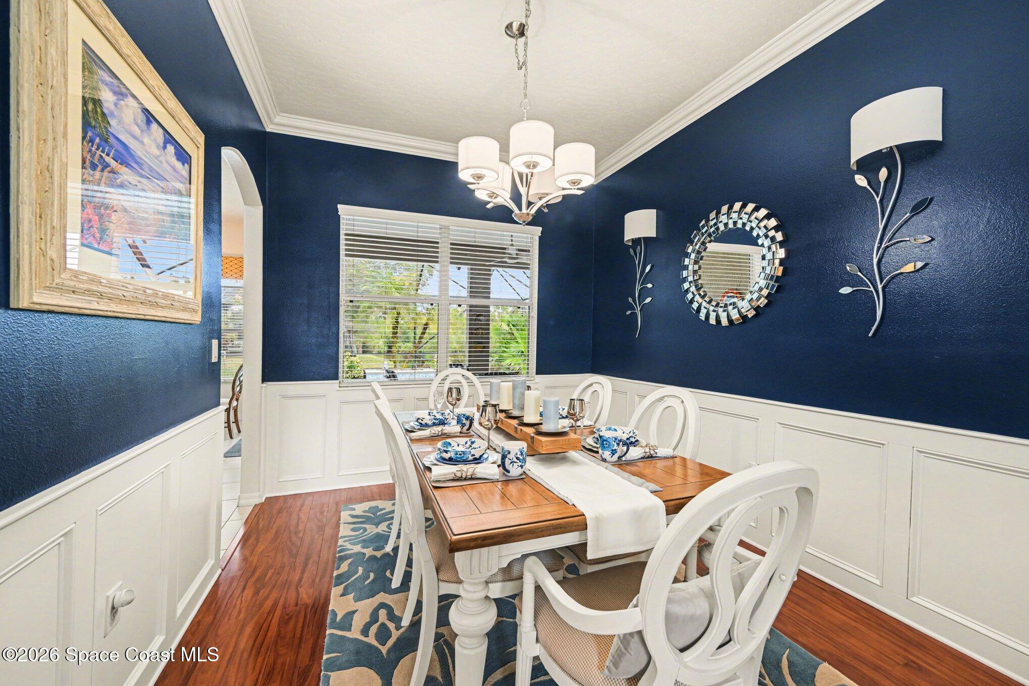 3760 Fringetree Lane Melbourne, FL 32940 - Photo 7 of 36 a view of a dining room with furniture a chandelier and wooden floor