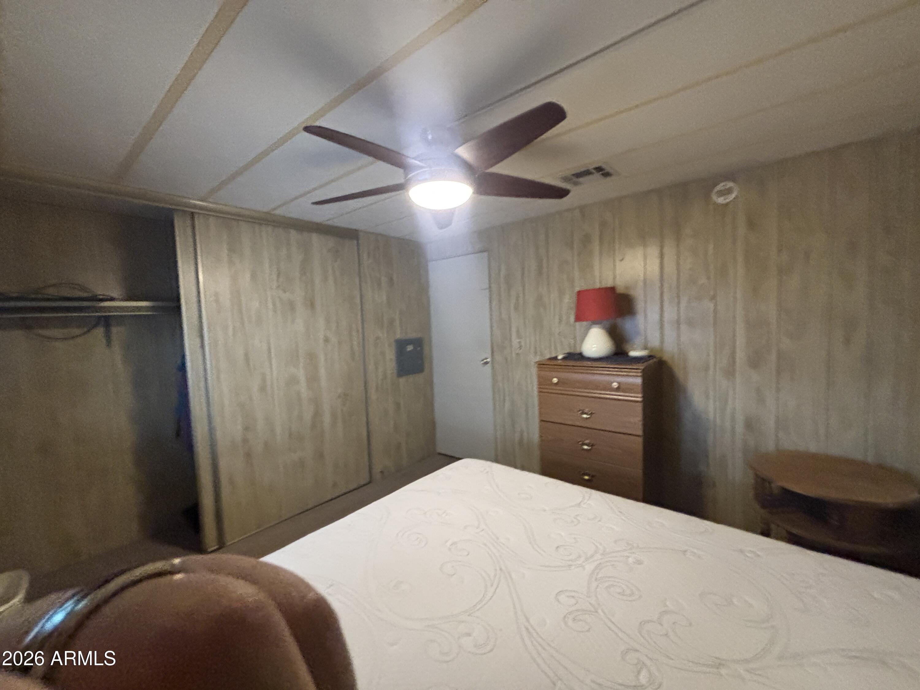 800 West Apache Trail, Unit 18 Apache Junction, AZ 85120 - Photo 16 of 24 a bedroom with a bed and a chandelier