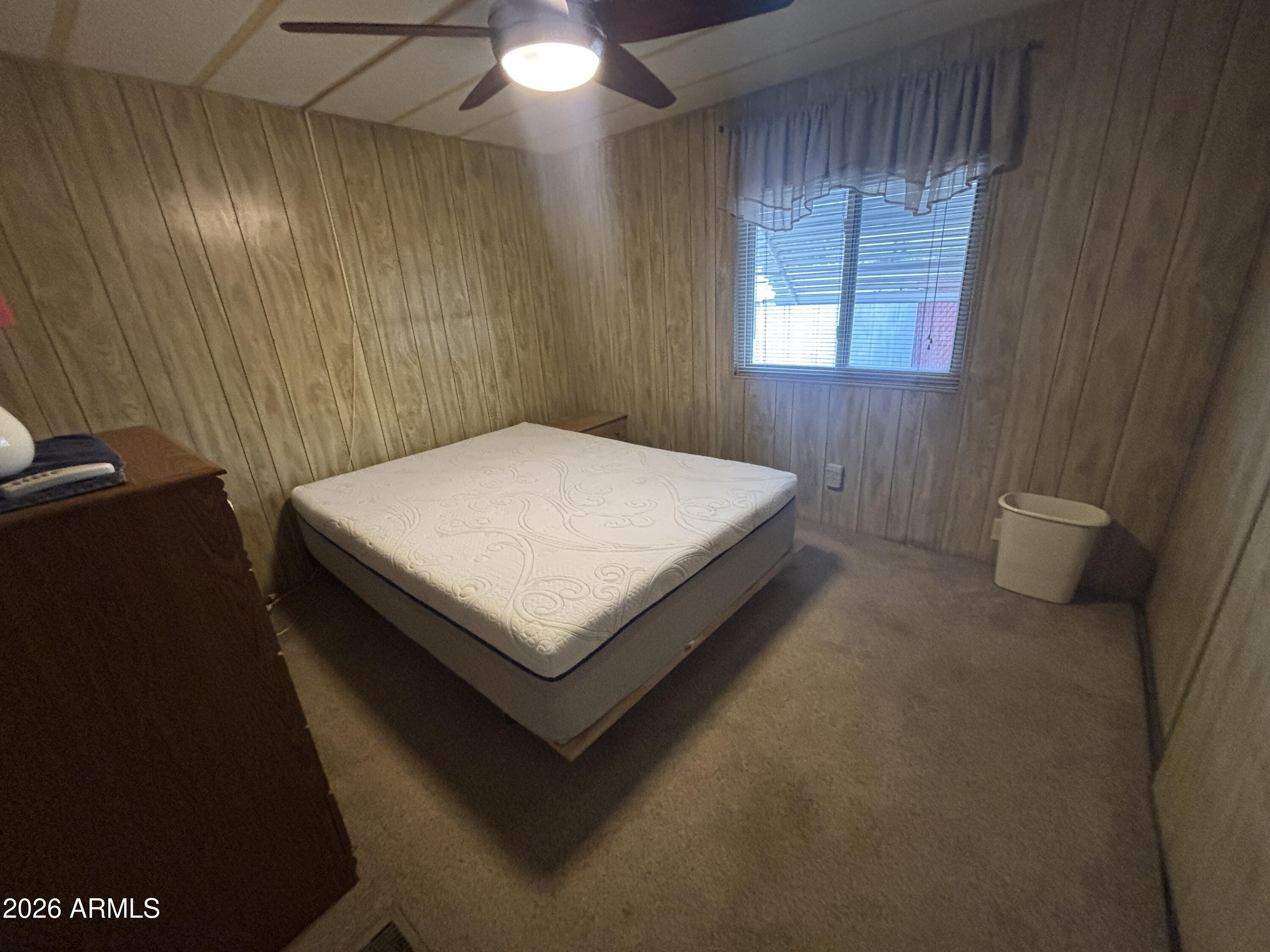 800 West Apache Trail, Unit 18 Apache Junction, AZ 85120 - Photo 17 of 24 a bed sitting in a bedroom next to a window