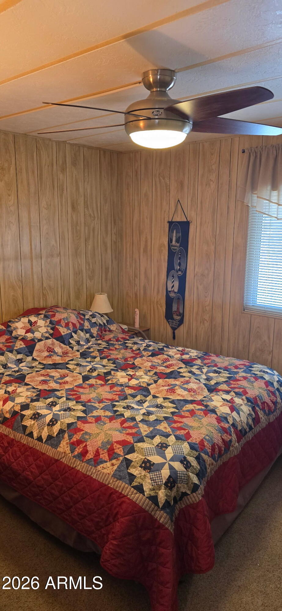 800 West Apache Trail, Unit 18 Apache Junction, AZ 85120 - Photo 20 of 20 a bedroom with a bed and a chandelier