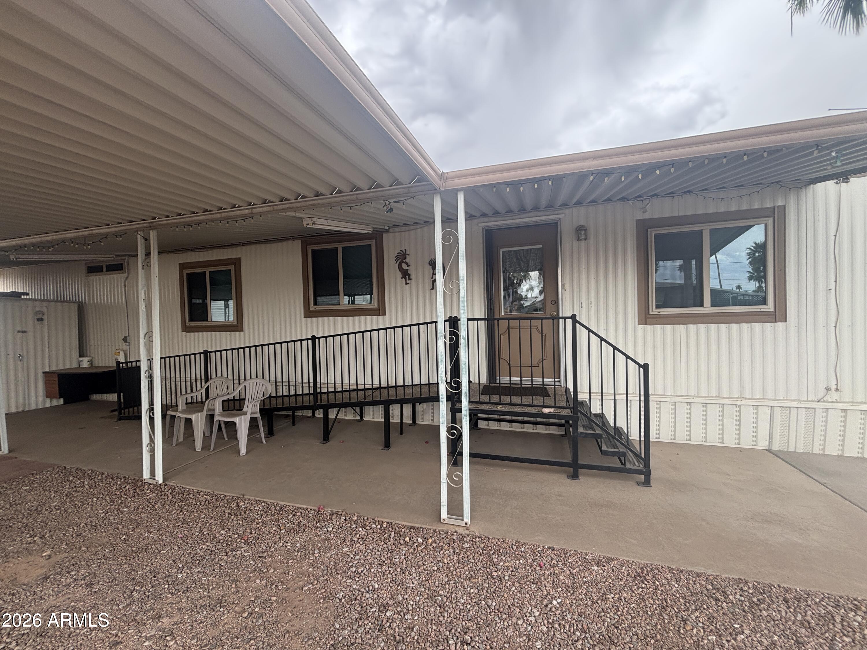 800 West Apache Trail, Unit 18 Apache Junction, AZ 85120 - Photo 2 of 24 a view of a porch with chairs