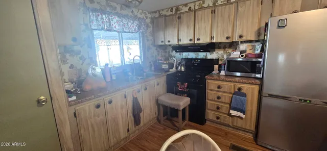 a kitchen with a refrigerator and a stove