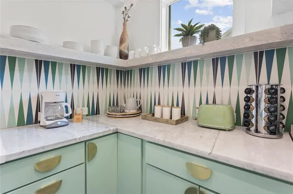 a kitchen with a sink a counter and cabinets