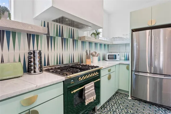 a kitchen with a stove and a refrigerator