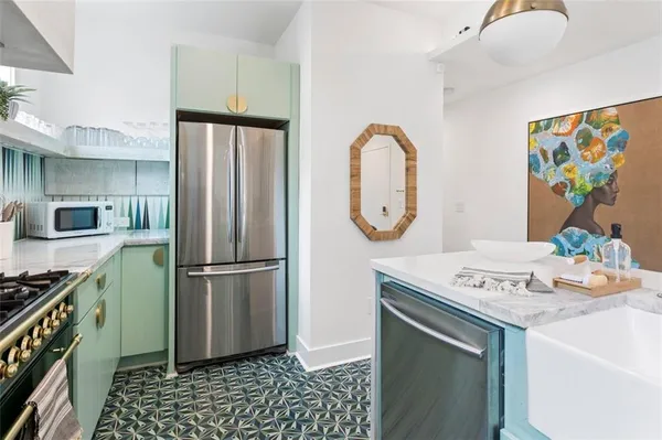 a kitchen with stainless steel appliances granite countertop a refrigerator sink and stove
