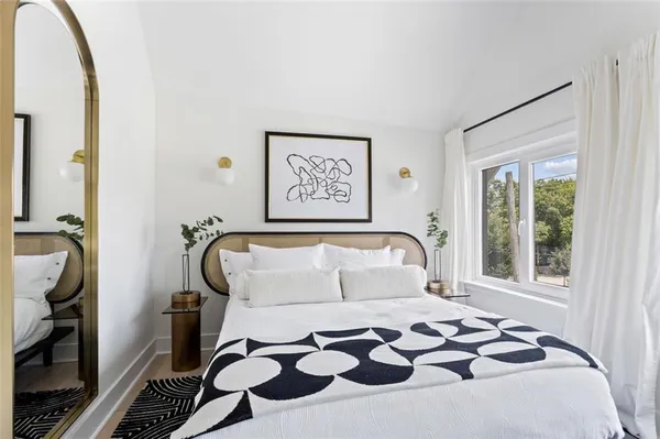 a bedroom with a bed and a window