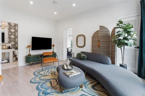 a living room with furniture a flat screen tv and a fireplace
