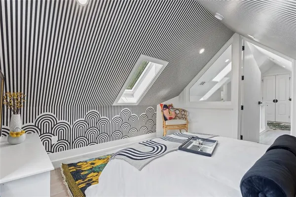 a bedroom with two beds and a lamp