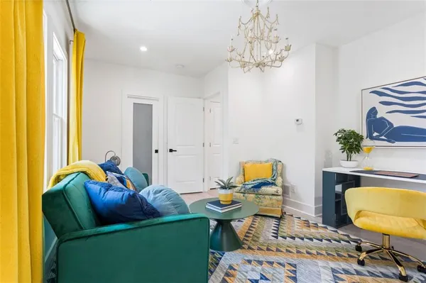 a living room with furniture and a chandelier