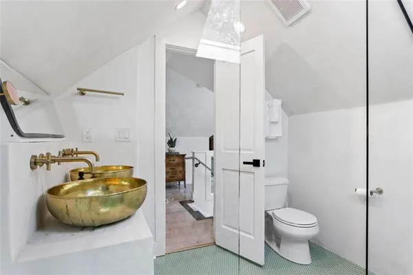 a bathroom with a mirror and a sink