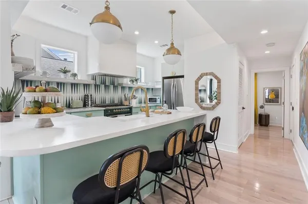 a kitchen with cabinets and chairs