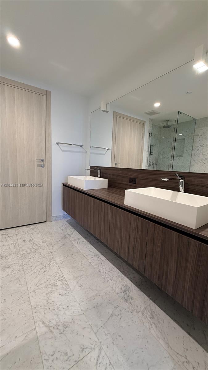 1000 Brickell, Unit 2014 Miami, FL 33131 - Photo 23 of 30 a kitchen with stainless steel appliances granite countertop a sink and cabinets
