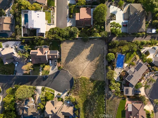 an aerial view of a house with a yard and a lot of lake view