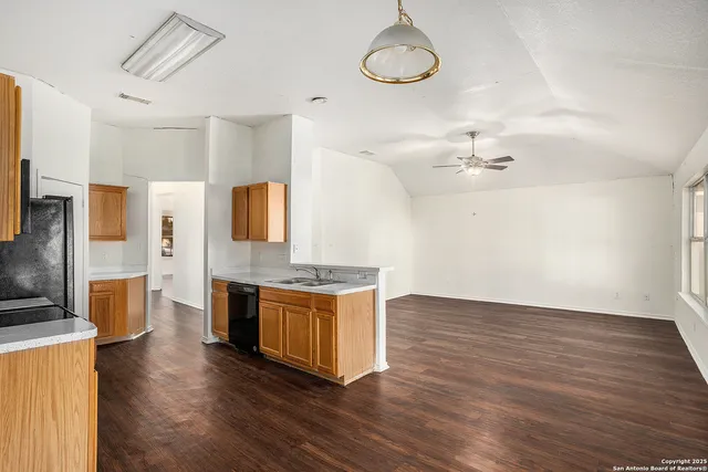 a kitchen with stainless steel appliances a stove and wooden floor
