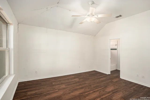 wooden floor in an empty room with a window