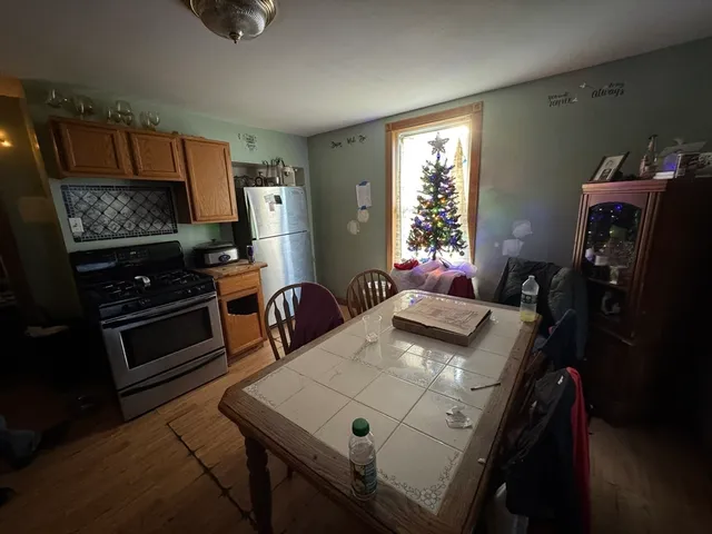a view of a dining room with furniture and a window