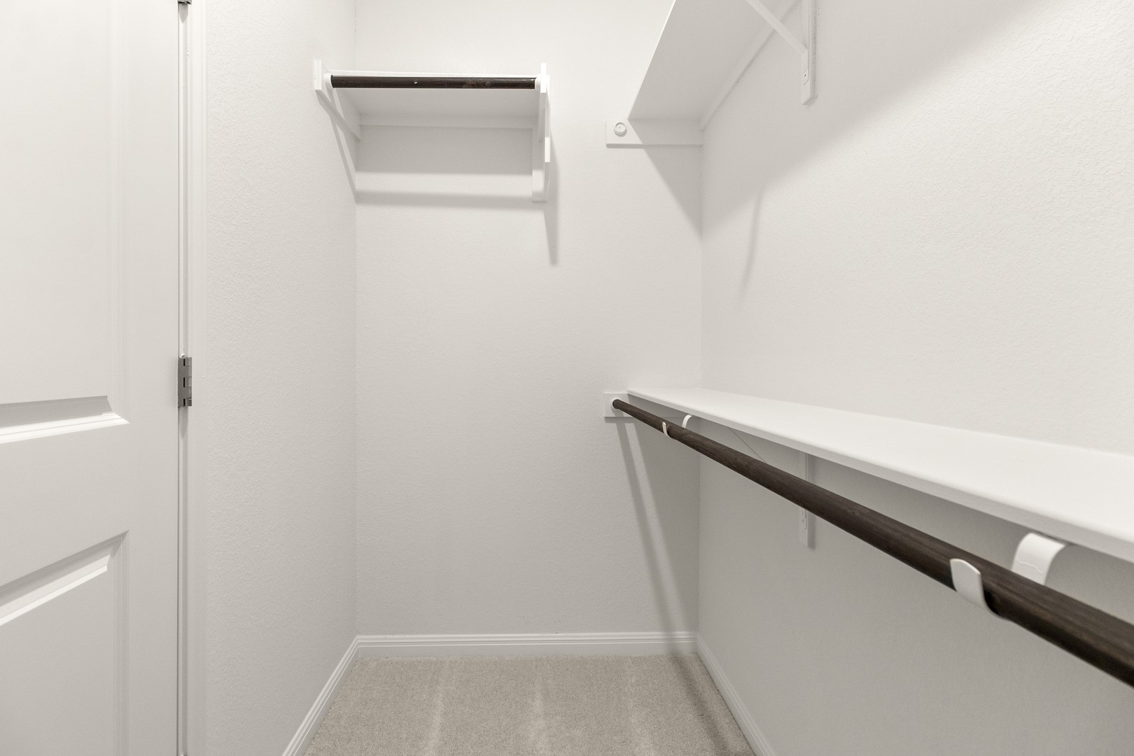 18605 Emu Lane Manor, TX 78653 - Photo 23 of 27 Closet space featuring white walls, light-colored carpeting, and white shelving with hanging rods