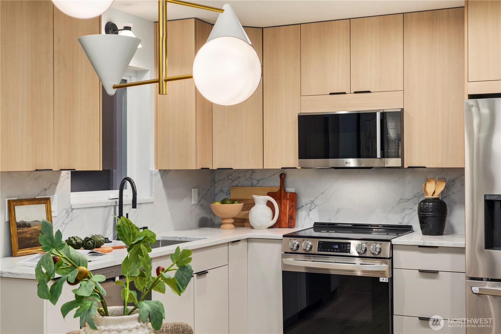 815 26th Avenue South, Unit B Seattle, WA 98144 - Photo 23 of 33 a kitchen with stainless steel appliances granite countertop a stove a microwave a sink and cabinets