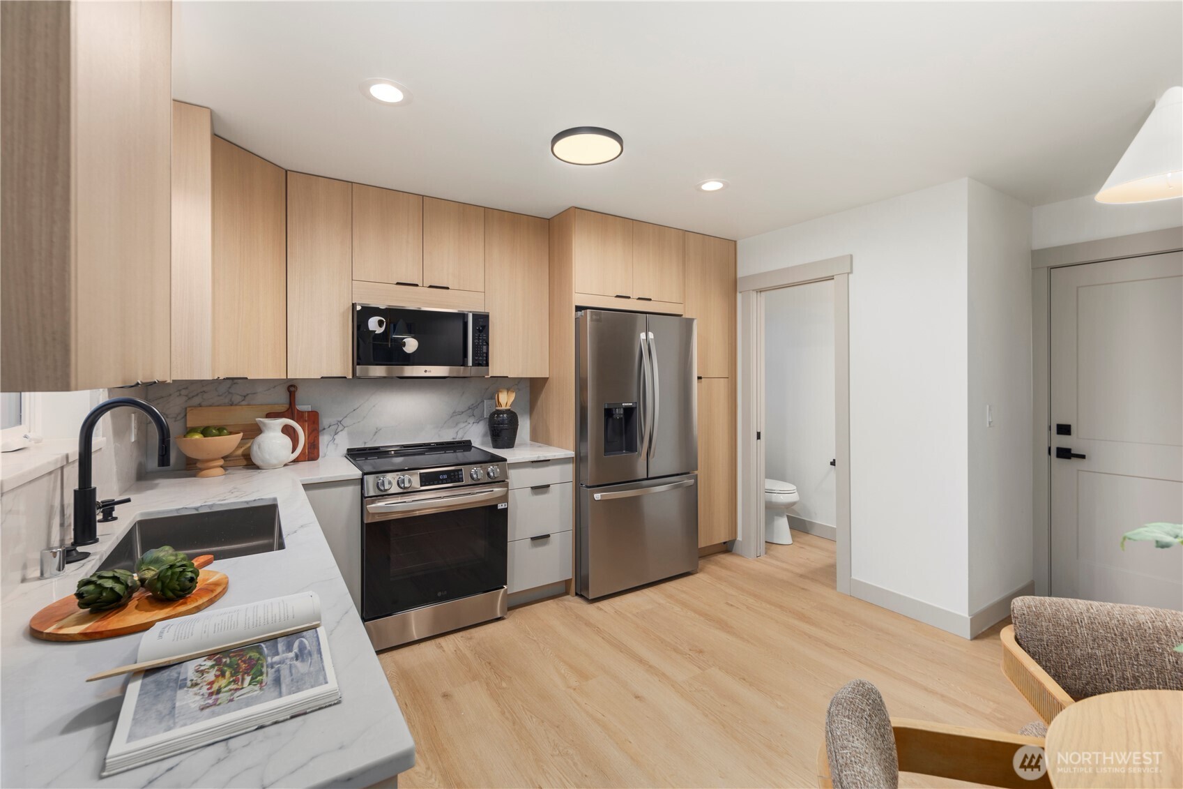815 26th Avenue South, Unit B Seattle, WA 98144 - Photo 6 of 33 a kitchen with stainless steel appliances granite countertop a sink a stove a refrigerator cabinets and a dining table