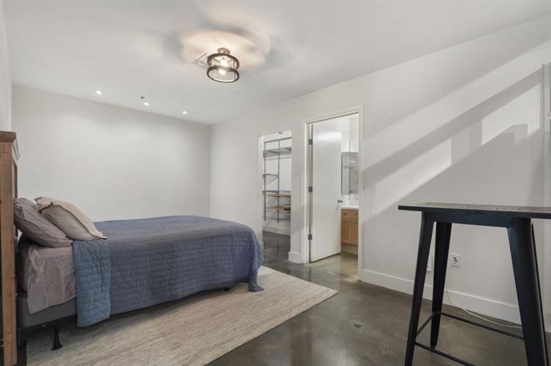 845 Spring Street Northwest, Unit 523 Atlanta, GA 30308 - Photo 4 of 21 a room with a bed and a mirror