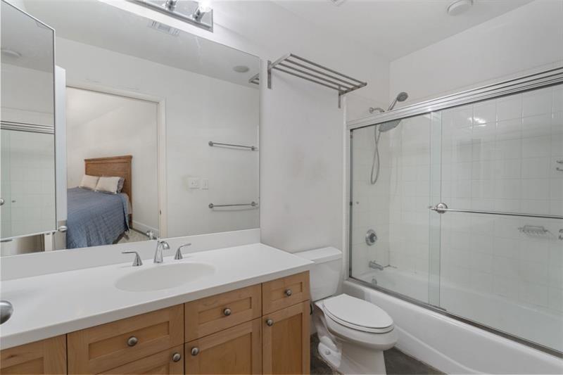 845 Spring Street Northwest, Unit 523 Atlanta, GA 30308 - Photo 7 of 21 a bathroom with a granite countertop sink toilet and shower