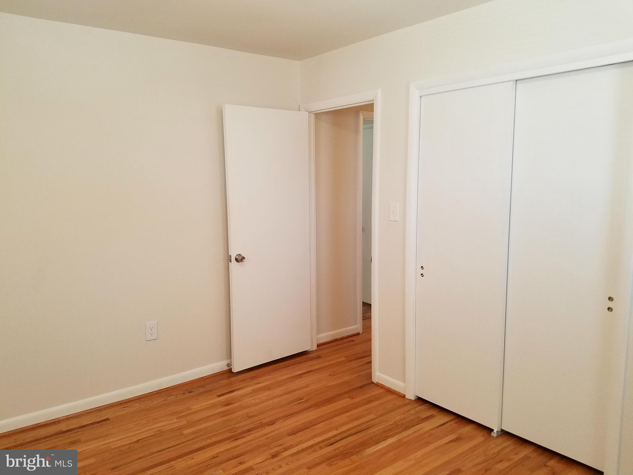 12908 Glynis Road Clinton, MD 20735 - Photo 20 of 30 a view of an empty room with wooden floor
