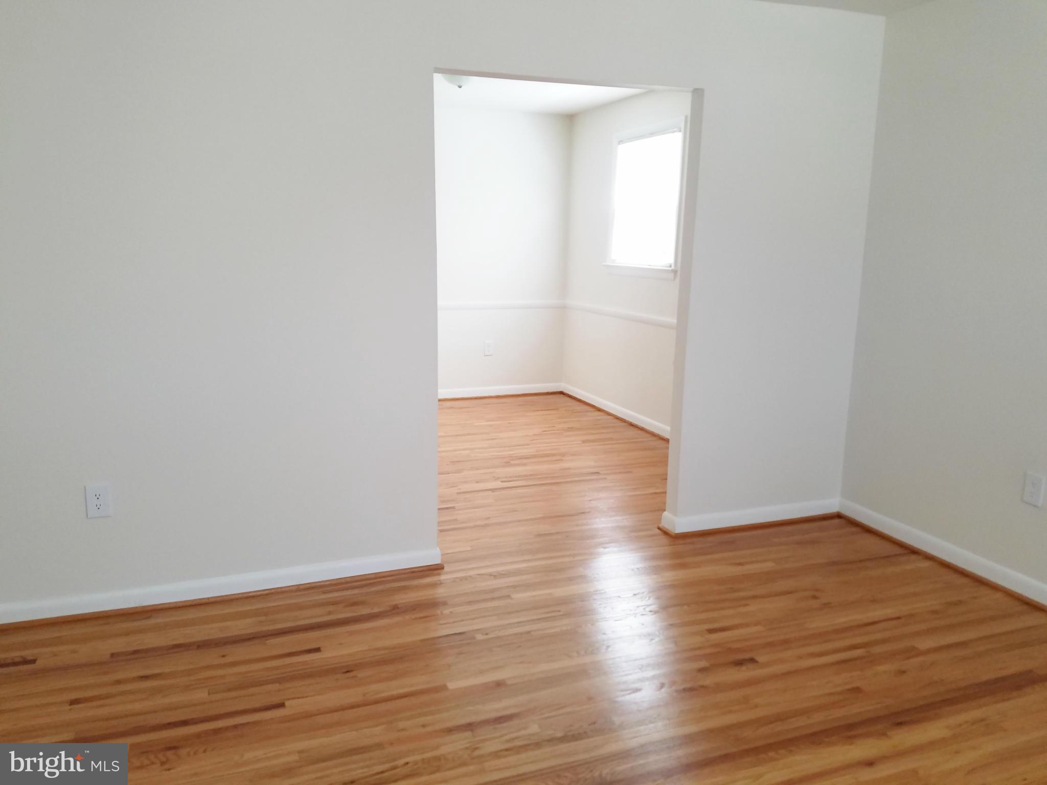 12908 Glynis Road Clinton, MD 20735 - Photo 10 of 30 a view of an empty room with wooden floor