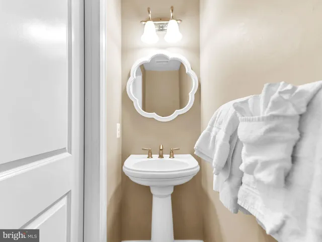 a dining room with furniture a chandelier and kitchen view