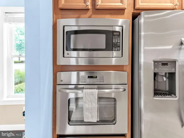 a living room with furniture wooden floor and a large window