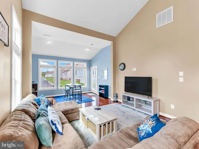 a view of a livingroom with furniture window and wooden floor