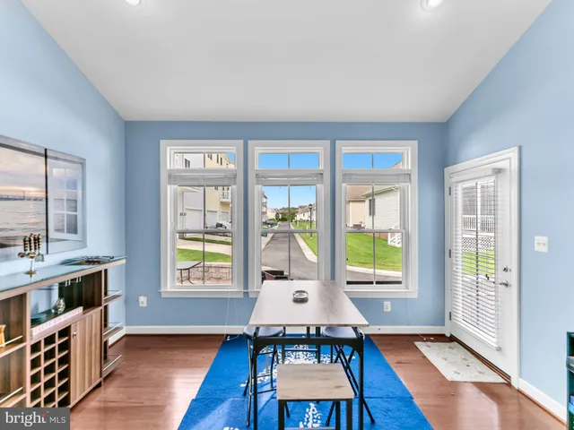 a bathroom with a granite countertop sink and a mirror with bathtub