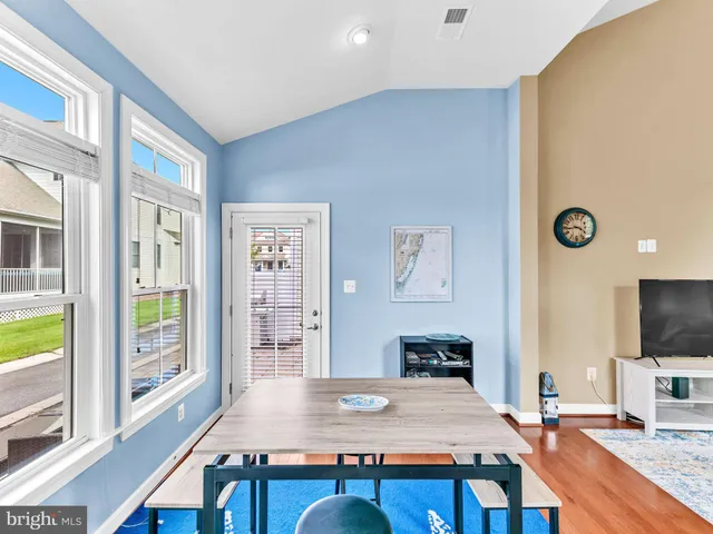 a bathroom with a granite countertop sink a mirror and a shower