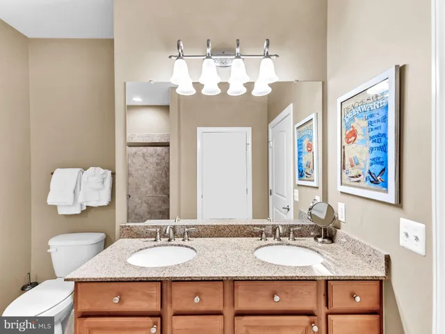 a bedroom with a bed and a dresser with potted plant