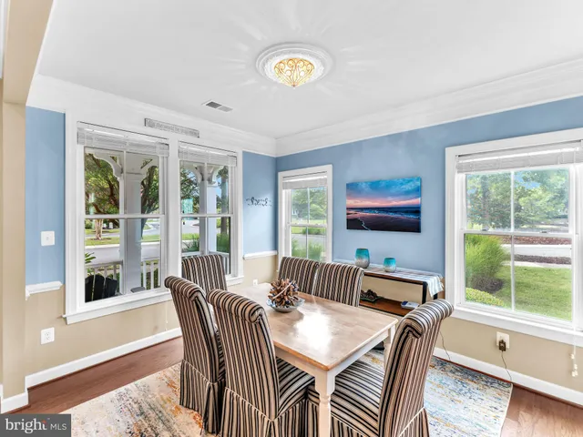 a view of a livingroom with furniture a floor to ceiling window and a flat screen tv