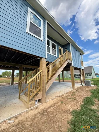 a view of a house with a wooden deck